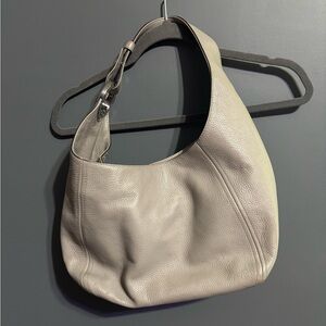 Micheal Kors grey purse with silver emblem on strap